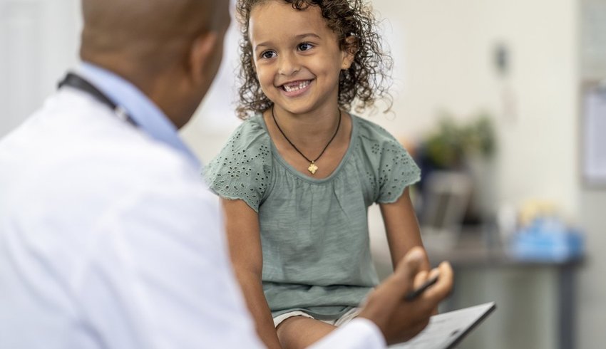Doctor speaking to a young girl in a consultation.