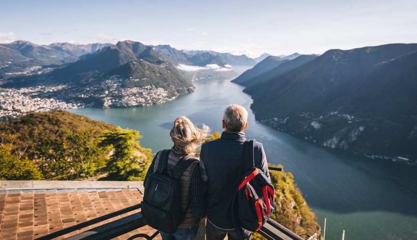 Couple in front of a mountain range and river.
