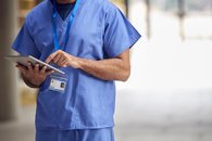 Doctor checking tablet