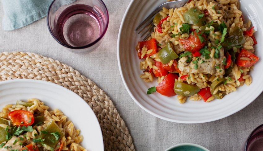 Kidney Kitchen orzo pasta presented in serving dishes on a table.