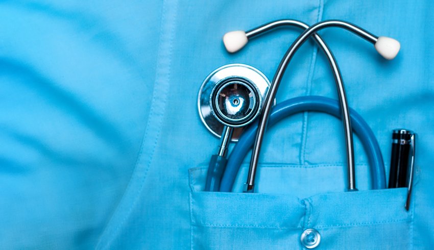 Stethoscope in the upper pocket of a medical professional.