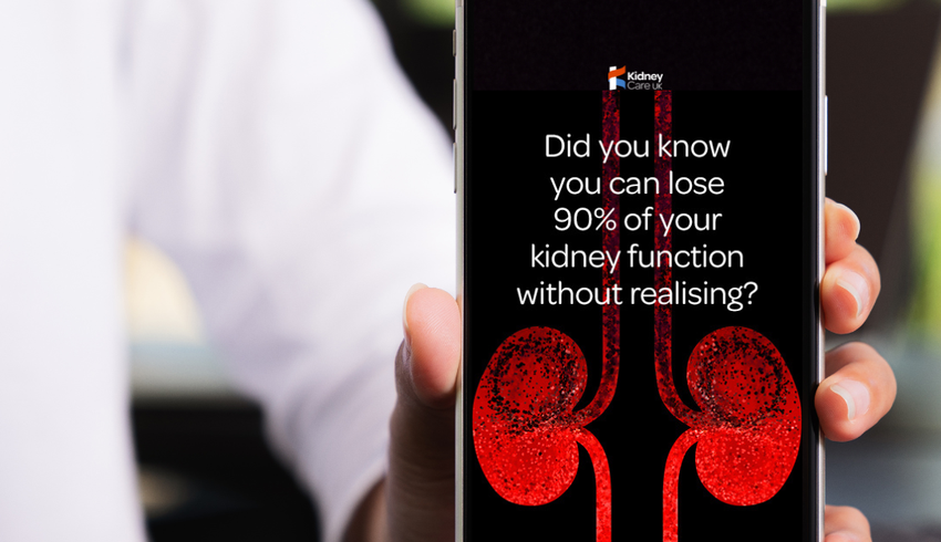 Hand holding a phone with an illustration of red kidneys on a black background for the #BloodyAmazingKidneys campaign.