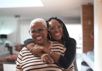 Two women hugging and smiling