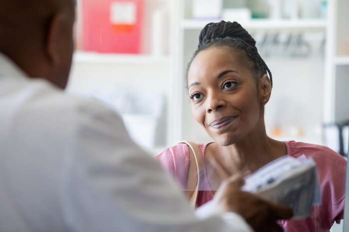 Woman speaking to doctor